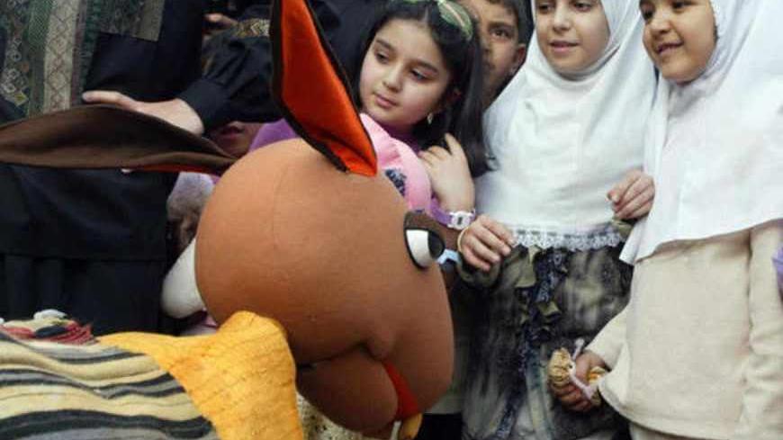 TEHRAN, IRAN:  Iranian girls gather to watch a puppet show during a festival to mark the world puppet theatre day at the Iranian artist's house in Tehran, 23 April 2004. AFP PHOTO/Behrouz MEHRI  (Photo credit should read BEHROUZ MEHRI/AFP/Getty Images)
