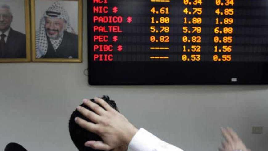 A Palestinian trader looks at the exchange board in the West Bank city of Nablus’ Stock Exchange on October 8, 2008. Arab stock markets tumbled for the fourth day running today amid growing fears that policymakers may be powerless to stop the worst financial shock since the Great Depression. AFP PHOTO /JAAFAR ASHTIYEH (Photo credit should read JAAFAR ASHTIYEH/AFP/Getty Images)