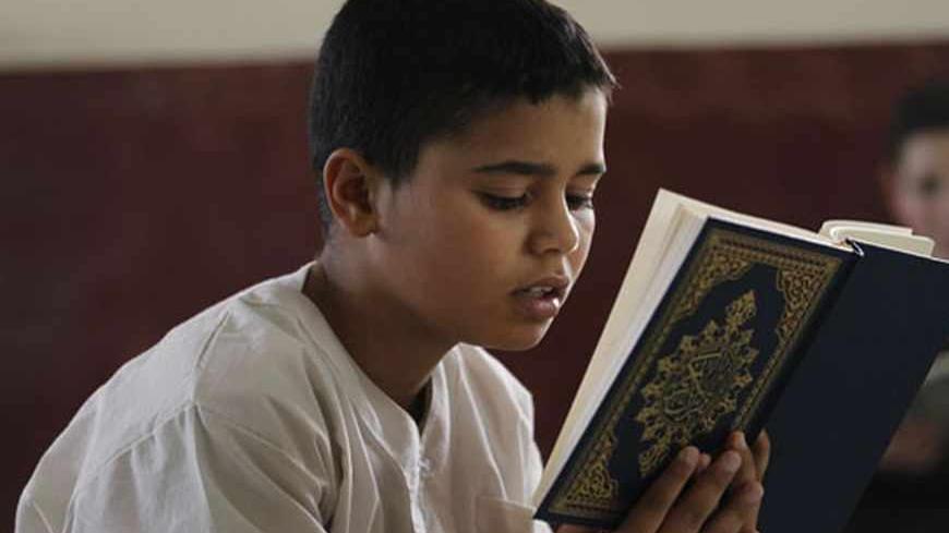 A pupil reads and learns the Koran at Zaouia Ait Koufi in Tizi Ouzou, east of Algiers, during the holy month of Ramadan August 8, 2012. REUTERS/Louafi Larbi (ALGERIA - Tags: RELIGION SOCIETY) - RTR36GIW