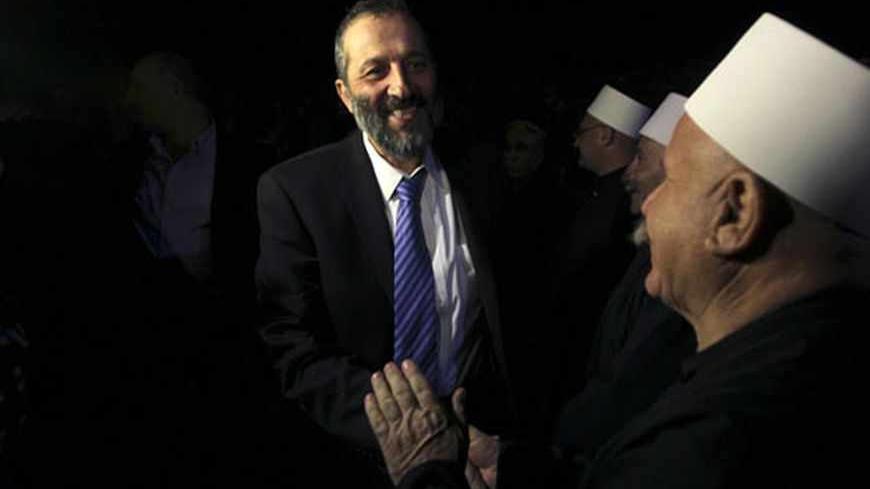 Shas party leader Aryeh Deri (C) greets members of the Druze community during a campaign rally in the Druze village of Abu Snan, in northern Israel January 2, 2013. Disillusioned, disappointed and divided, Israeli Arab voters will traipse to the polls next week in ever dwindling numbers, aware that none of their community will have any say in how the country is run. In 2009 some Arab votes went to the Ultra-Orthodox Shas party, which campaigns openly in Israeli Arab towns, promising ever more generous welfa