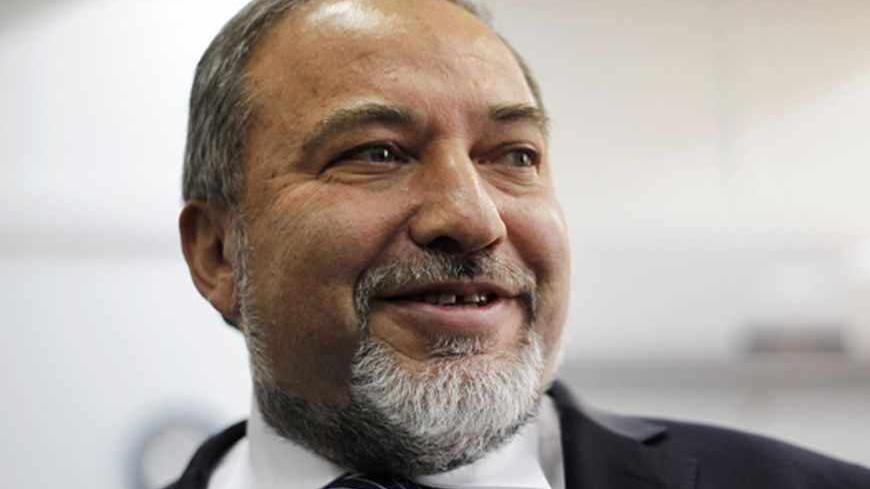 Avigdor Lieberman, former Israeli foreign minister, looks on in the courtroom before the opening hearing of his trial at Jerusalem's magistrate court February 17, 2013. Lieberman's trial began in Jerusalem on Sunday and he pleaded not guilty to charges of fraud and breach of trust, allegations that prompted his resignation as foreign minister in December. REUTERS/Ariel Schalit/Pool (JERUSALEM - Tags: POLITICS CRIME LAW) - RTR3DWUI