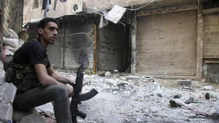 A Free Syrian Army fighter sits on sandbags in the refugee camp of Yarmouk, near Damascus, May 5, 2013. REUTERS/Ward Al-Keswani  (SYRIA - Tags: POLITICS CIVIL UNREST) - RTXZBH6