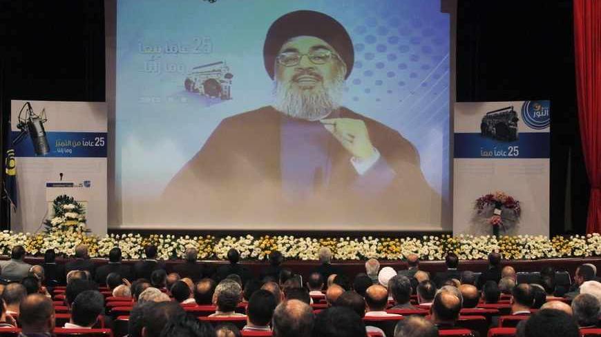 Lebanon's Hezbollah leader Sayyed Hassan Nasrallah is projected on a screen during a live broadcast as he speaks to his supporters at an event marking the 25th anniversary of the establishment of Al-Nour radio station, which is operated by the Hezbollah in Beirut, May 9, 2013. REUTERS/Sharif Karim (LEBANON - Tags: POLITICS MEDIA ANNIVERSARY) - RTXZGEB