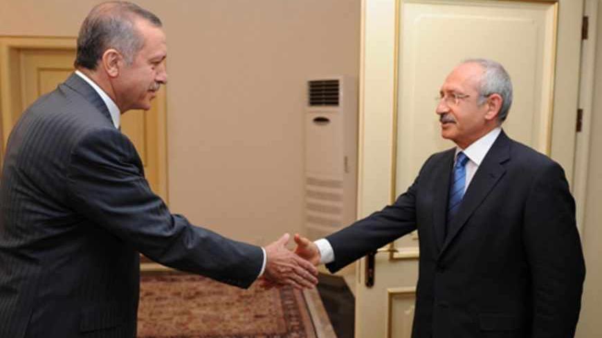 Turkish Prime Minister Recep Tayyip Erdogan shakes hands with main opposition Republican People's Party (CHP) leader Kemal Kilicdaroglu (R) as they meet in Ankara June 24, 2012. Turkey accused Syria on Sunday of shooting down a military plane in international airspace without warning and called a NATO meeting to discuss a response to Syrian President Bashar al-Assad. Amid growing acrimony between the once-friendly neighbours, Syria said its forces had shot dead "terrorists" infiltrating its territory from T