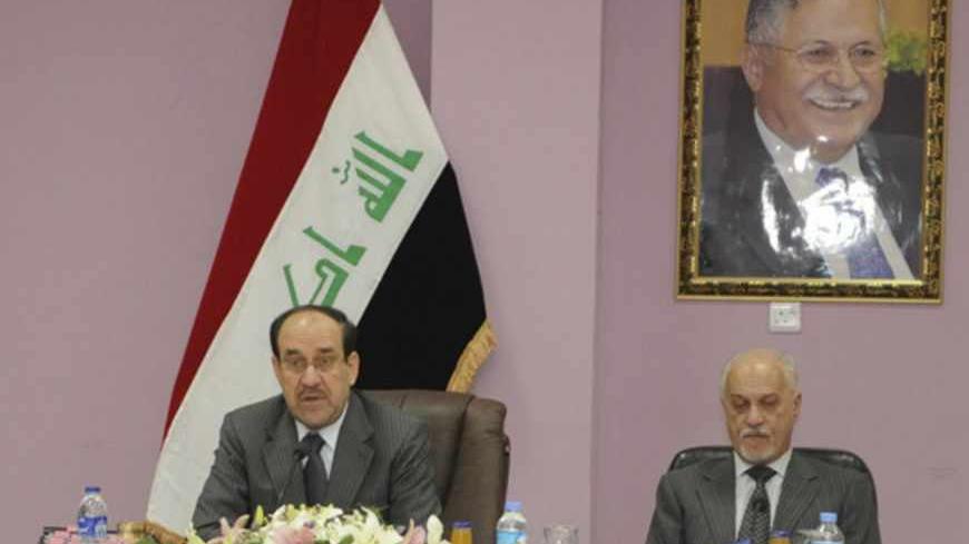 Iraqi Prime Minister Nuri al-Maliki (L) speaks next to Iraq's Deputy Prime Minister for Energy Hussain al-Shahristani during a meeting of the Council of Ministers in Kirkuk, 250 km (155 miles) north of Baghdad May 8, 2012. On top right hangs a picture of Iraq's President Jalal Talabani. REUTERS/Iraqi Prime Minister Media Office/Handout (IRAQ - Tags: POLITICS) FOR EDITORIAL USE ONLY. NOT FOR SALE FOR MARKETING OR ADVERTISING CAMPAIGNS. THIS IMAGE HAS BEEN SUPPLIED BY A THIRD PARTY. IT IS DISTRIBUTED, EXACTLY