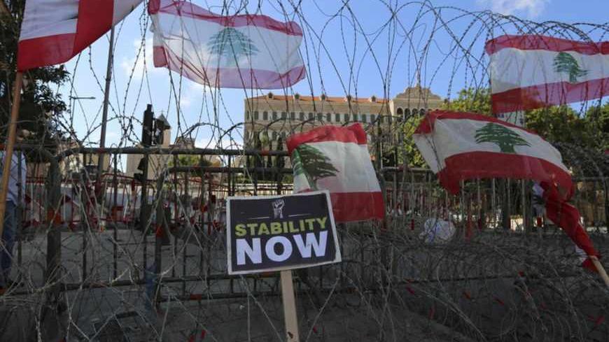 Lebanese flags placed by anti-government protesters are seen on barbed wire securing the area in front of the government palace in downtown Beirut October 25, 2012. The party capital of the Arab world, Beirut is a freewheeling city where Gulf Arabs, expatriates and Lebanese emigres fly in to enjoy its luxury hotels. But under the veneer of modernity lie sectarian demons coiled to strike. The car-bomb assassination last Friday of intelligence chief Wissam al-Hassan - an attack almost universally blamed on Sy