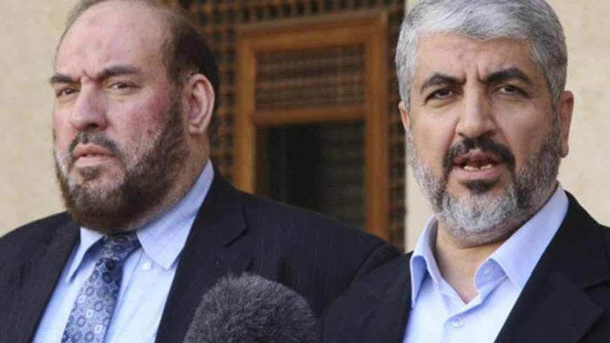 Hamas leader Khaled Meshaal (R) and Mohammad Nazzal, a member of the Hamas leadership, speak to media after their meeting with Jordan's King Abdullah at the Royal Palace in Amman January 28, 2013.  REUTERS/Majed Jaber (JORDAN - Tags: POLITICS) - RTR3D30A