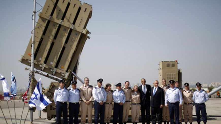 U.S. President Barack Obama (7th R) and Israeli Prime Minister Benjamin Netanyahu (6th R) pose with members of Israel's defense force as he views an Iron Dome Battery at Ben Gurion International Airport Airport in Tel Aviv March 20, 2013. Obama said at the start of his first official visit to Israel on Wednesday that the U.S. commitment to the security of the Jewish state was rock solid and that peace must come to the Holy Land.   REUTERS/Jason Reed (ISRAEL - Tags: POLITICS MILITARY) - RTR3F84T