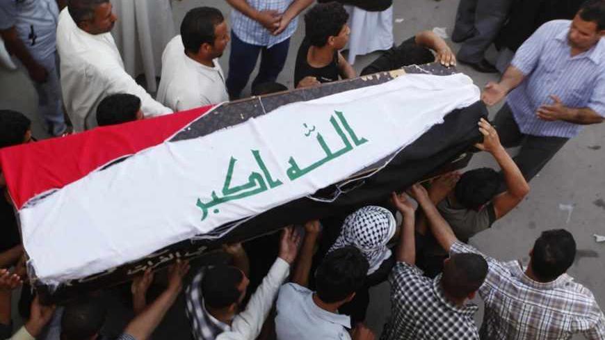 Relatives carry the coffin of an Iraqi soldier killed by militants during a funeral in Najaf, 160 km (100 miles) south of Baghdad, April 28, 2013. Militants shot dead five Iraqi soldiers in the Sunni Muslim stronghold province of Anbar on Saturday and protesters said they were forming an "army" after four days of unrest that raised fears of a return to widespread sectarian civil conflict. REUTERS/Haider Ala  (IRAQ - Tags: CIVIL UNREST MILITARY) - RTXZ2XI