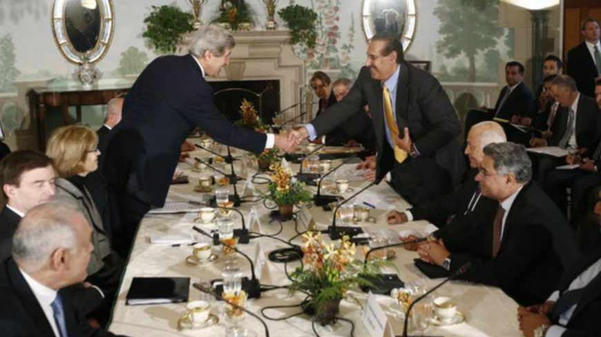 U.S. Secretary of State John Kerry (L) shakes hands with Qatar's Prime Minister Sheikh Hamad bin Jassim al-Thani as they meet with members of the Arab League at Blair House in Washington April 29, 2013.    REUTERS/Jason Reed     (UNITED STATES - Tags: POLITICS) - RTXZ41T