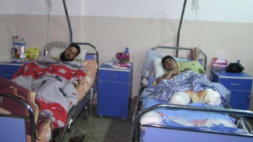 Wounded Syrian refugees who activists said were injured during shelling by forces loyal to Syrian President Bashar al-Assad, lie in a hospital at Bab El-Hawa on the outskirts of Idlib, near the Syrian-Turkish border April 30, 2013. The Syrian air strike on a headquarters of a rebel brigade along the Turkish border killed at least five people, including children, and wounded dozens more on Tuesday, opposition activists said. Picture taken April 30, 2013.   REUTERS/Abdalghne Karoof (SYRIA - Tags: CONFLICT POL