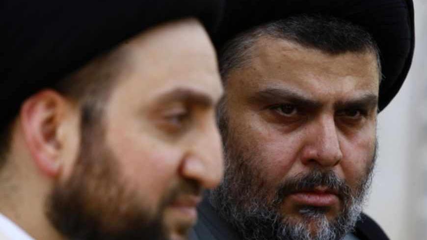 Iraqi Shi'ite cleric Moqtada al-Sadr (R) and Ammar al-Hakim, leader of the Islamic Supreme Council of Iraq (ISCI), hold a news conference in Najaf, 160 km (100 miles) south of Baghdad, May 8, 2013.  REUTERS/Haider Ala  (IRAQ - Tags: POLITICS) - RTXZEUT