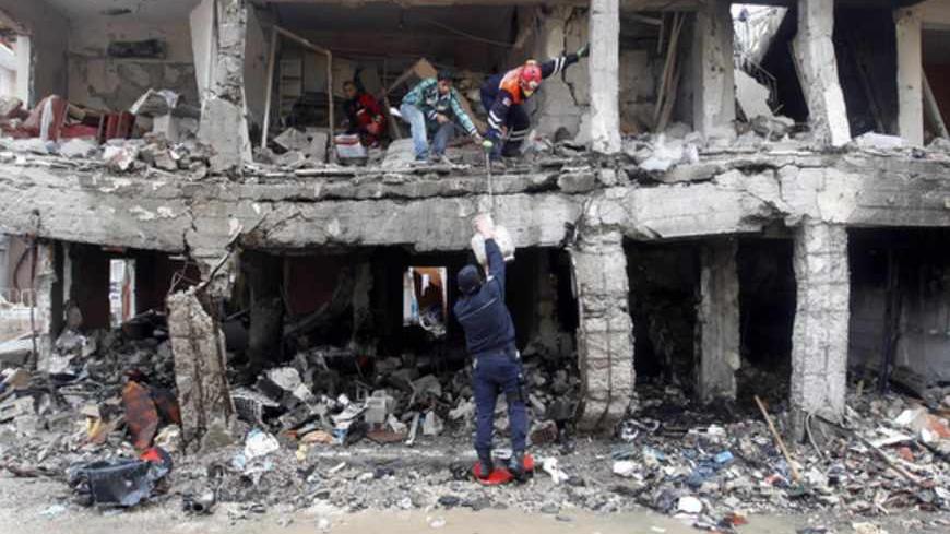 Search and rescue officers work at a damaged building at the site of blast in the town of Reyhanli in Hatay province, near the Turkish-Syrian border, May 13, 2013. Syria's information minister has blamed Turkey's government for deadly car bombings near the Syrian border and branded Prime Minister Tayyip Erdogan a "murderer", state-run Russian TV company RT reported on Monday. It said he repeated a denial of Syrian involvement in car bombings that killed 46 people on Saturday in the Turkish border town of Re