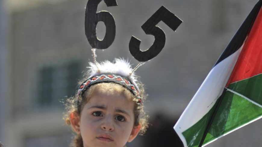 A Palestinian girl attends a Nakba rally in Gaza City May 15, 2013. Palestinians will mark "Nakba" (Catastrophe) on May 15 to commemorate the expulsion or fleeing of some 700,000 Palestinians from their homes in the war that led to the founding of Israel in 1948.  REUTERS/Mohammed Salem (GAZA - Tags: POLITICS CIVIL UNREST) - RTXZN2A