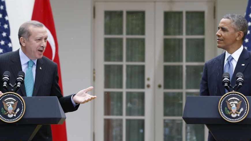 Turkish Prime Minister Recep Tayyip Erdogan (L) answers a question as he and U.S. President Barack Obama hold a joint news conference in the White House Rose Garden in Washington, May 16, 2013. REUTERS/Jason Reed (UNITED STATES  - Tags: POLITICS)   - RTXZPBV