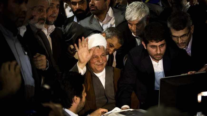 Former Iranian president Akbar Hashemi Rafsanjani (C) waves as he registers his candidacy for the upcoming presidential election at the interior ministry in Tehran on May 11, 2013. Rafsanjani, who has been isolated since the 2009 presidential election which saw massive street protests against the disputed re-election of President Mahmoud Ahmadinejad, registered his candidacy to stand for office again. AFP PHOTO/BEHROUZ MEHRI        (Photo credit should read BEHROUZ MEHRI/AFP/Getty Images)