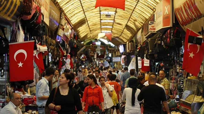 People shop in a shopping district in Hatay May 17, 2013. Turkey hailed its second investment grade rating on Friday, seeing it as a seal of approval from international markets for a decade of economic reform. Investors joined in, driving sovereign bond yields to record lows. Government enthusiasm was tempered, however, by some concern that the move, coinciding with a visit by Turkey's Prime Minister Tayyip Erdogan to Washington, might trigger over-large capital inflows into the lira currency. REUTERS/Umit 