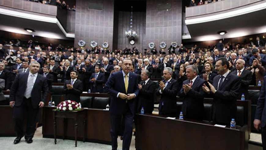 Turkey's Prime Minister Tayyip Erdogan leaves his seat to address members of parliament from the ruling AK Party (AKP) during a meeting at the Turkish parliament in Ankara February 19, 2013. REUTERS/Umit Bektas (TURKEY - Tags: POLITICS) - RTR3DZE4