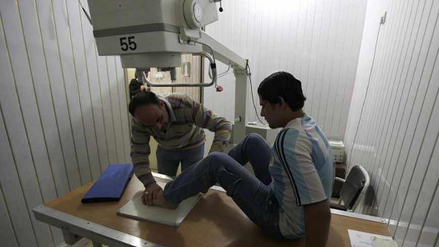 A physical therapist treats a patient at a medical clinic in Baghdad March 8, 2011. Development in Iraq has been stifled by decades of economic sanctions and war and SMEs, often seen as the backbone of a country's economy, have made little progress in Iraq due to high start-up costs and scant government funding. Chronic power and water shortages, ongoing security concerns and high customs tariffs have all made it difficult for a small business sector to emerge. Picture taken March 8, 2011.       To match fe