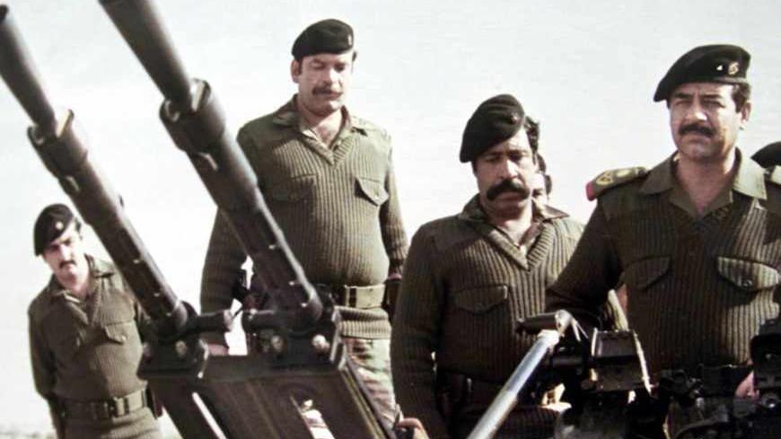 Saddam Hussein (R) stands with his guards behind him at an artillery
piece during the Iraq-Iran war in this undated file photo. The picture
is among exhibits at The Leader's Museum in Baghdad. British Prime
Minister Tony Blair published a dossier on Iraq's weapons programme on
Tuesday which claimed Saddam could launch weapons of mass destruction
at just 45 minutes' notice and was seeking to build a nuclear
capability. REUETRS/Handout

FK - RTRB072