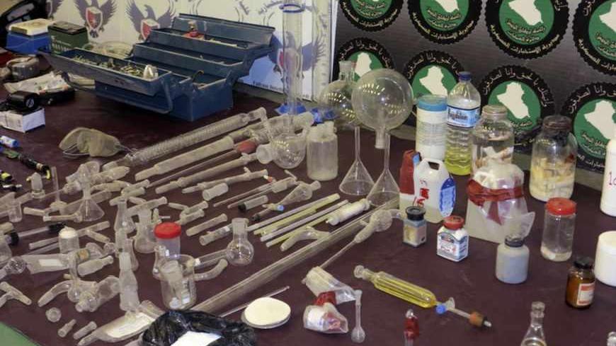 Laboratory equipment and chemicals are seen on display during a news conference at the Defence Ministry in Baghdad June 1, 2013. The materials were confiscated from four men who have been arrested, and are accused of planning to make chemical weapons like nerve and mustard gas, according to the ministry.                    REUTERS/Stringer (IRAQ - Tags: CIVIL UNREST CRIME LAW) - RTX10825