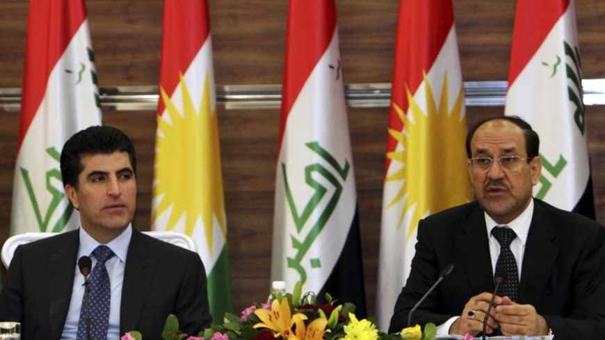 Iraqi Prime Minister Nuri al-Maliki (R) speaks next to his Iraqi Kurdish counterpart Nechirvan Barzani during a meeting of the Council of Ministers in Arbil, about 350 km (220 miles) north of Baghdad June 9, 2013. Maliki visited the Kurdistan region on Sunday for the first time in more than two years, in an attempt to resolve a long-running dispute over oil and land that has strained Iraq's unity to the limit. REUTERS/Azad Lashkari (IRAQ - Tags: POLITICS) - RTX10H5T