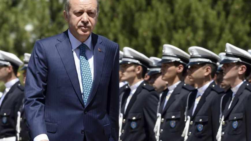 Turkey's Prime Minister Tayyip Erdogan reviews students of the Police Academy upon his arrival to their graduation ceremony in Ankara June 24, 2013. REUTERS/Stringer (TURKEY - Tags: POLITICS CRIME LAW) - RTX10YXL