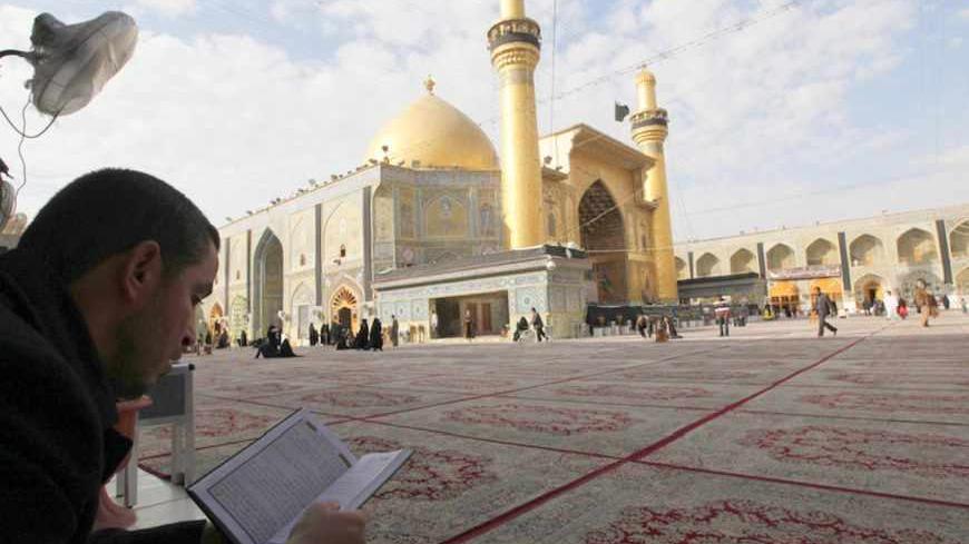 A Shi'ite Muslim reads a book at the Imam Ali shrine in Najaf, 160 km (100 miles) south of Baghdad, January 9, 2011. REUTERS/Mohammed Ameen  (IRAQ - Tags: RELIGION SOCIETY) - RTXWD4I