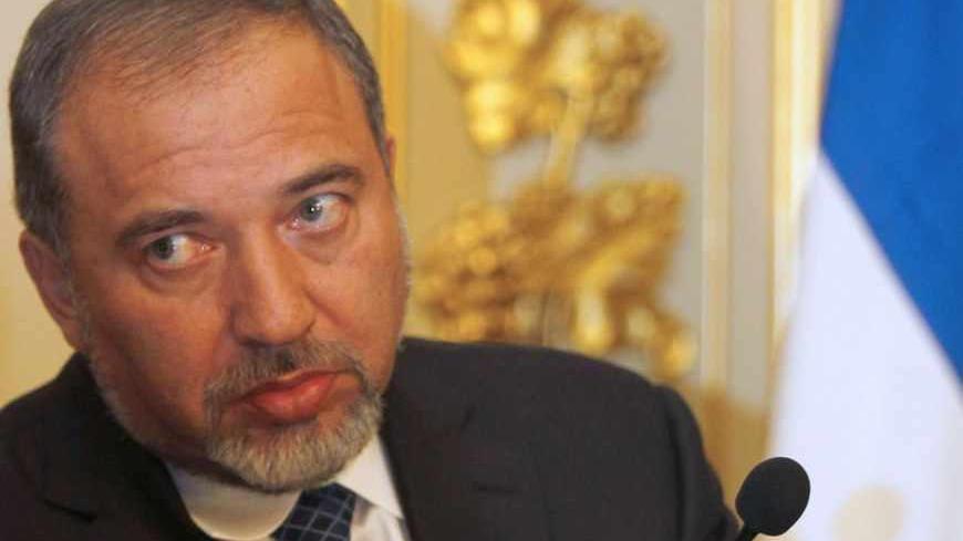 Israel's Foreign Affairs Minister Avigdor Liberman listens to a translator during a news conference with his Portuguese counterpart Luis Amado after their meeting in Lisbon January 25, 2011.  REUTERS/Jose Manuel Ribeiro  (PORTUGAL - Tags: POLITICS) - RTXX2FL