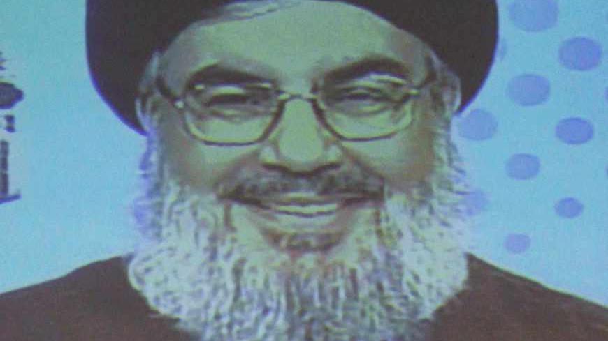 Lebanon's Hezbollah leader Sayyed Hassan Nasrallah is projected on a screen during a live broadcast as he speaks to his supporters at an event marking the 25th anniversary of the establishment of Al-Nour radio station, which is operated by the Hezbollah in Beirut, May 9, 2013. REUTERS/Sharif Karim (LEBANON - Tags: POLITICS MEDIA ANNIVERSARY) - RTXZGEC