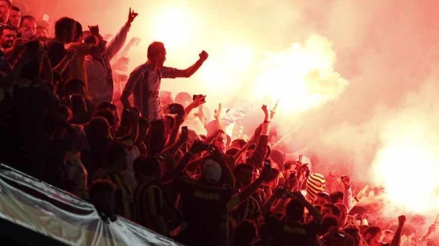 Fenerbahce fans light flares during the Turkish Super League derby soccer match against Galatasaray at Sukru Saracoglu stadium in Istanbul May 12, 2013. REUTERS/Osman Orsal (TURKEY - Tags: SPORT SOCCER TPX IMAGES OF THE DAY) - RTXZK2O