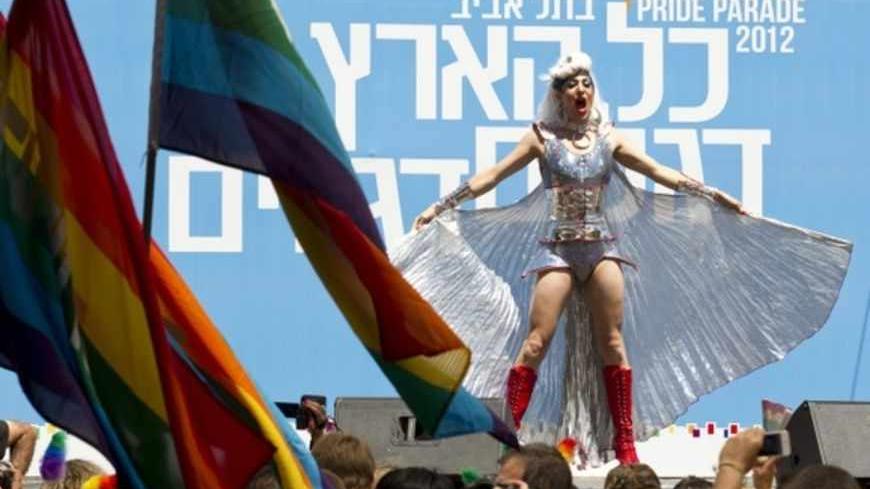 A drag queen singer in heavy makeup performs in front of tens of thousands of participants, during the opening of the annual Gay Pride parade in the Mediterranean city of Tel Aviv on June 8, 2012. AFP PHOTO/JACK GUEZ        (Photo credit should read JACK GUEZ/AFP/GettyImages)