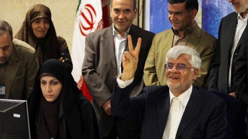 Iranian former Vice-President Mohammad Reza Aref flashes the sign of victory as he registers his candidacy for the upcoming presidential election at the interior ministry in Tehran on May 10, 2013. Iran began a five-day registration period for candidates in Iran's June 14 presidential election, with a string of conservative hopefuls in the running but with key reformists yet to come forward, media reports said. AFP PHOTO/ATTA KENARE        (Photo credit should read ATTA KENARE/AFP/Getty Images)