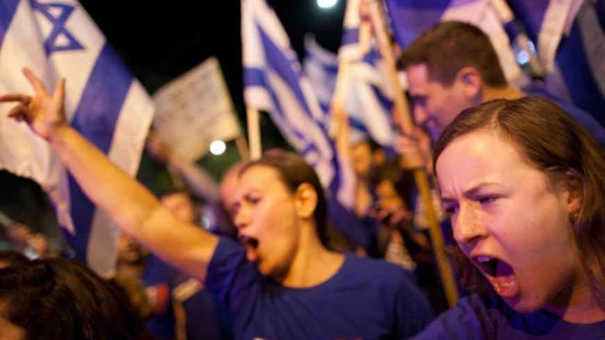 TEL AVIV, ISRAEL - MAY 11:  (ISRAEL OUT) Demonstrators march through the streets to protest against Israeli Finance Minister Yair Lapid's budget cuts on May 11, 2013 in Tel Aviv, Israel. Thousands of Israelis took to the streets to protest against austerity measures presented this week as part of the state's new budget.  (Photo by Uriel Sinai/Getty Images)