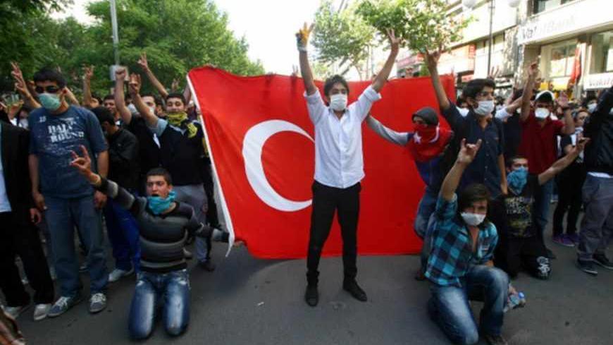 TuTurkish protesters holding a Turkish flag demonstrate on the main city square, Kizilay, in the Turkish capital Ankara on June 3, 2013. rkish Prime Minister Recep Tayyip Erdogan on Monday rejected talk of a "Turkish Spring", shrugging off mass protests against his government as medics reported the first death in days of violence. Rallies started there last week initially in protest at plans to redevelop the adjacent Gezi Park, a rare green spot in central Istanbul, and quickly spread, inflamed by anger at 