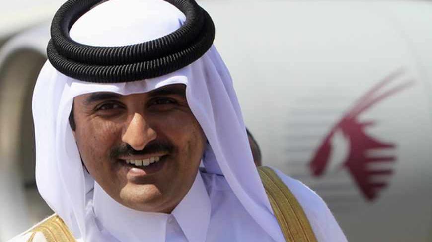 Qatar's Crown Prince Sheikh Tamim Bin Hamad Al Thani smiles during his arrival for an economic ties visit at Khartoum Airport  December 4, 2011. REUTERS/Mohamed Nureldin Abdallah (SUDAN - Tags: POLITICS ROYALS BUSINESS) - RTR2UTVY