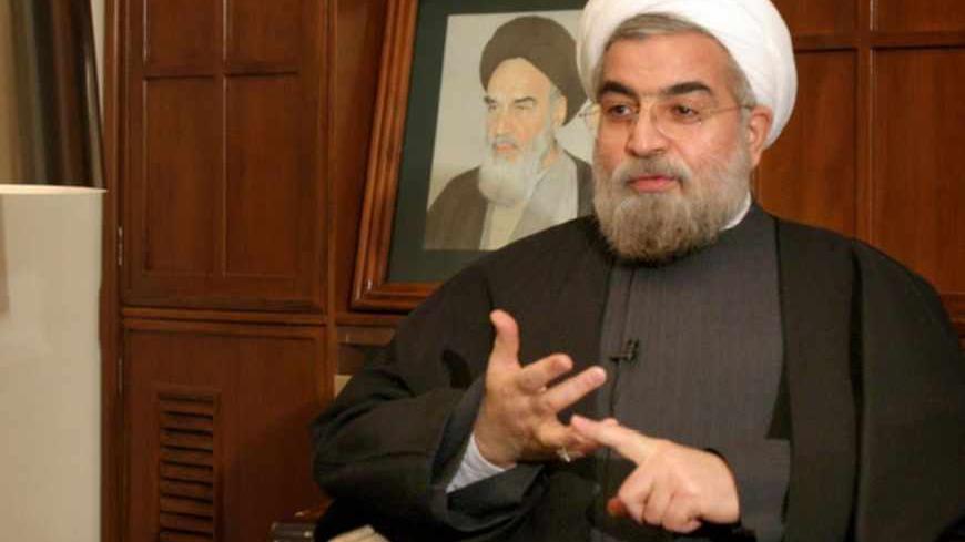 Iran's chief nuclear negotiator Hassan Rohani speaks with a Reuters correspondent during a private interview in Tehran February 6, 2005. REUTERS/Raheb Homavandi  RH/CJF/AA - RTRMHK5