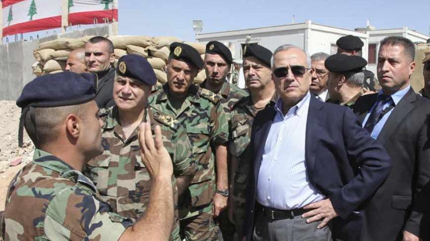 Lebanon's President Michel Suleiman (2nd R), accompanied by Lebanese army commander General Jean Kahwaji (2nd L), inspects the site of the army checkpoint where three Lebanese soldiers were killed on Tuesday near the town of Arsal, in the eastern Bekaa Valley, May 29, 2013. Gunmen killed three Lebanese soldiers at an army checkpoint in the eastern Bekaa Valley on Tuesday before fleeing towards the Syrian border, Lebanese officials said. Dalati Nohra/Handout via Reuters  (LEBANON - Tags: POLITICS CIVIL UNRES