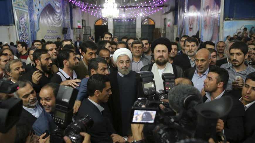 Iranian President-elect Hassan Rohani (C) speaks to the media following a visit to the Khomeini mausoleum in Tehran June 16, 2013. Reuters/Fars News/Seyed Hassan Mousavi   (IRAN - Tags: POLITICS) ATTENTION EDITORS - THIS IMAGE WAS PROVIDED BY A THIRD PARTY. FOR EDITORIAL USE ONLY. NOT FOR SALE FOR MARKETING OR ADVERTISING CAMPAIGNS. THIS PICTURE IS DISTRIBUTED EXACTLY AS RECEIVED BY REUTERS, AS A SERVICE TO CLIENTS - RTX10Q47