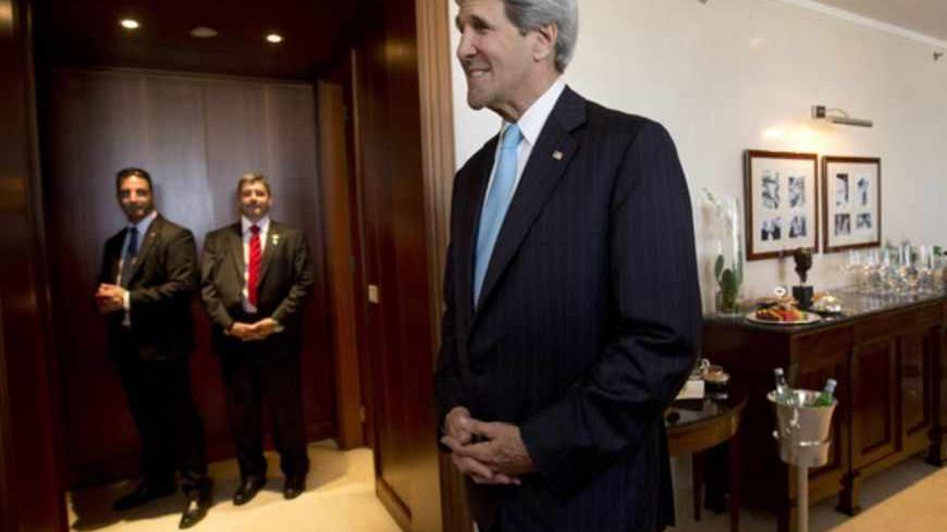U.S. Secretary of State John Kerry waits to greet Israeli Prime Minister Benjamin Netanyahu in Jerusalem, June 28, 2013. After seeing Palestinian President Mahmoud Abbas in Jordan, Kerry travelled to Jerusalem for evening talks with Netanyahu - a meeting that had been originally expected on Saturday. REUTERS/Jacquelyn Martin/Pool (JERUSALEM - Tags: POLITICS) - RTX114VG