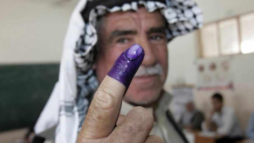 An internally displaced Iraqi man shows his ink-stained finger to the media after voting at a polling centre during the country's provincial elections in Kirkuk, 250 km (155 miles) north of Baghdad, April 20, 2013. Iraqis voted for provincial councils on Saturday in their first ballot since U.S. troops left the country, a key measure of political strength before parliamentary elections next year. Iraqi politics are deeply split along sectarian lines with Prime Minister Nuri al-Maliki's government mired in c