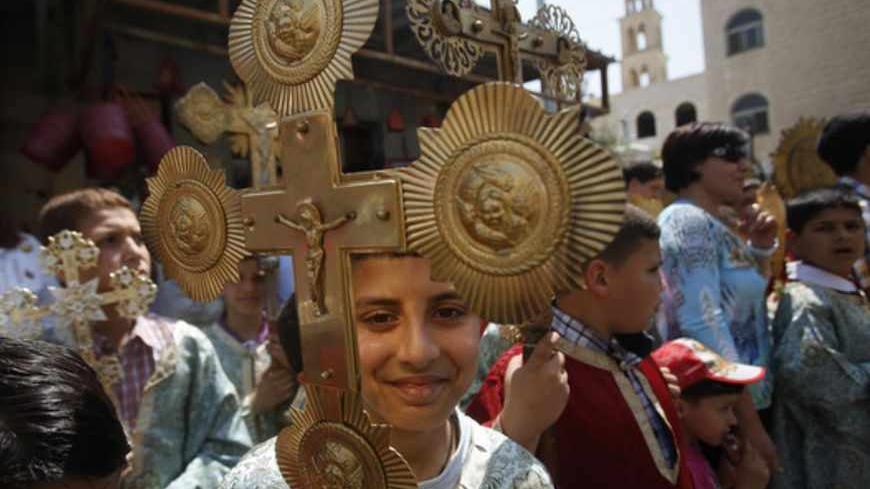 Palestinian Orthodox Christians parade as they celebrate the arrival of the 'Holy Fire' from Jerusalem's Holy Sepulchre in the occupied West Bank city of Ramallah May 4, 2013. REUTERS/Mohamad Torokman (WEST BANK - Tags: RELIGION TPX IMAGES OF THE DAY) - RTXZA2N