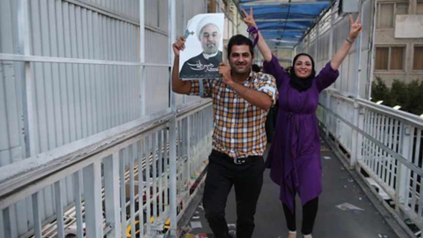 Supporters of moderate cleric Hassan Rohani celebrate his victory in Iran's presidential election on a pedestrian bridge in Tehran June 15, 2013. Rohani won Iran's presidential election on Saturday, the interior ministry said, scoring a surprising landslide victory over conservative hardliners without the need for a second round run-off. REUTERS/Fars News/Amir Hashen Dehgani (IRAN - Tags: POLITICS ELECTIONS TPX IMAGES OF THE DAY) 

ATTENTION EDITORS - THIS IMAGE WAS PROVIDED BY A THIRD PARTY. FOR  EDITORIAL