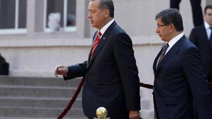 Turkey's Prime Minister Tayyip Erdogan (L) and Foreign Minister Ahmet Davutoglu arrive at a ceremony in Ankara September 6, 2011. Erdogan said on Tuesday that Turkey was "totally suspending" defence industry ties with Israel, after downgrading diplomatic relations with the Jewish state. REUTERS/Umit Bektas (TURKEY - Tags: POLITICS) - RTR2QV66