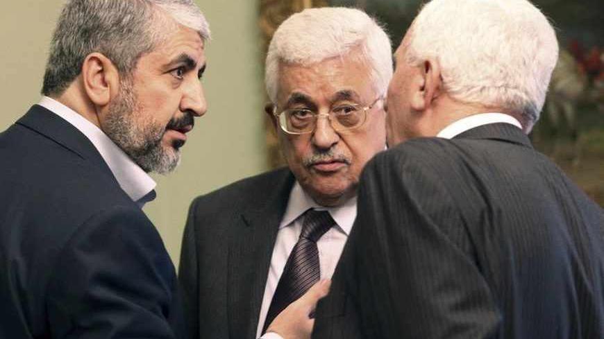 Hamas leader Khaled Meshaal (L) and Palestinian President Mahmoud Abbas (C) talk with an official during their meeting in Cairo November 24, 2011. The leaders of Fatah and Hamas met for the first time in six months on Thursday and hailed progress toward ending Palestinian divisions that has led to separate governments in the West Bank and Gaza Strip, but there was no sign of a breakthrough.  REUTERS/Mohamed Al Hams/Handout  (EGYPT - Tags: POLITICS) FOR EDITORIAL USE ONLY. NOT FOR SALE FOR MARKETING OR ADVER