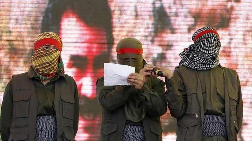 Masked supporters of jailed Kurdish rebel leader Abdullah Ocalan stand on the stage as one reads a statement during a gathering to celebrate Newroz in the southeastern Turkish city of Diyarbakir  March 21, 2013. Jailed Kurdish rebel leader Abdullah Ocalan ordered his fighters on Thursday to cease fire and withdraw from Turkish soil as a step to ending a conflict that has killed 40,000 people, riven the country and battered its economy. Hundreds of thousands of Kurds gathered in the regional centre of Diyarb