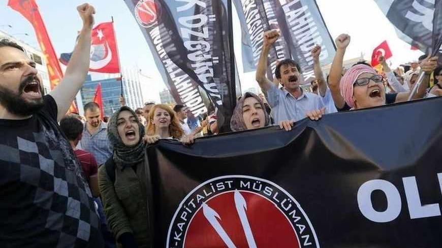 Anti-government protesters, who call themselves ''anti-capitalist Muslims'', shout slogans during a demonstration in Istanbul June 23, 2013. The European Union is on the verge of scrapping a new round of membership talks with Turkey, a move that would further undermine Ankara's already slim hopes of joining the bloc and damage its relations with Brussels. Germany, the EU's biggest economic power, is blocking efforts to revive Turkey's EU membership bid, partly because of its handling of anti-government prot