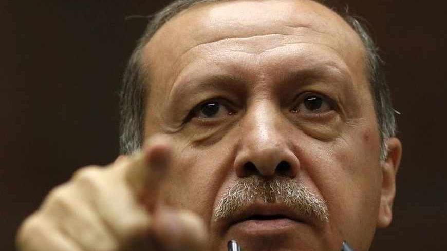 Turkey's Prime Minister Tayyip Erdogan addresses members of parliament from his ruling AK Party (AKP) during a meeting at the Turkish parliament in Ankara June 25, 2013. Turkish anti-terrorism police detained 20 people in raids in the capital Ankara on Tuesday in connection with weeks of anti-government protests across the country, media reports said. The unrest began at the end of May when police used force against campaigners opposed to plans to redevelop a central Istanbul park. The protest spiralled int