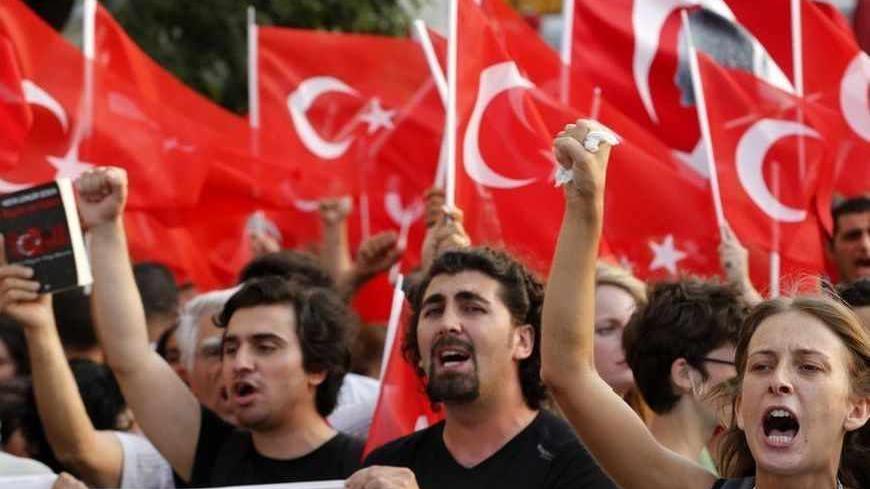 Protesters shout slogans during an anti-government protest at Taksim Square in Istanbul June 29, 2013. Thousands of protesters marched to Istanbul's Taksim Square on Saturday chanting slogans against the government and police after security forces killed a Kurdish demonstrator in southeastern Turkey. The protest had been planned as part of larger unrelated anti-government demonstrations that have swept through the country since the end of May, but became a voice of solidarity with the Kurds after Friday's k