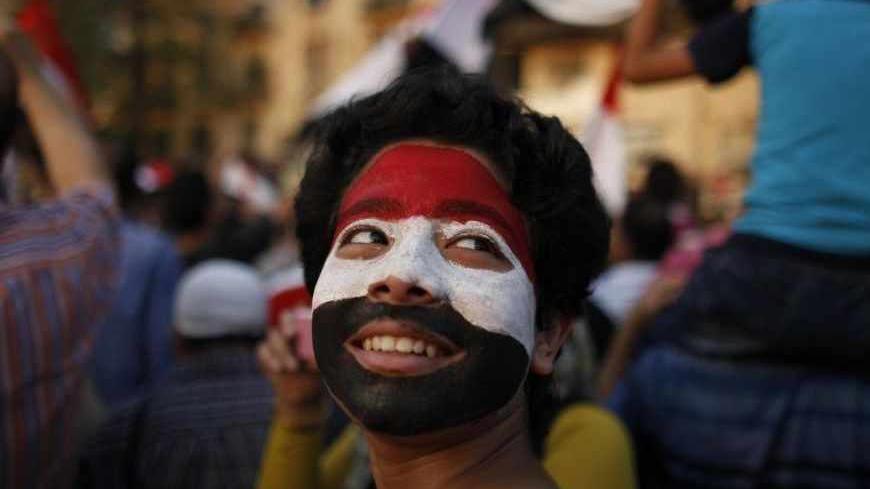 A boy with his face painted in the colours of Egypt's national flag attends a rally held by anti-Mursi protesters at Tahrir square in Cairo July 4, 2013. REUTERS/Khaled Abdullah (EGYPT - Tags: POLITICS CIVIL UNREST) - RTX11CR8